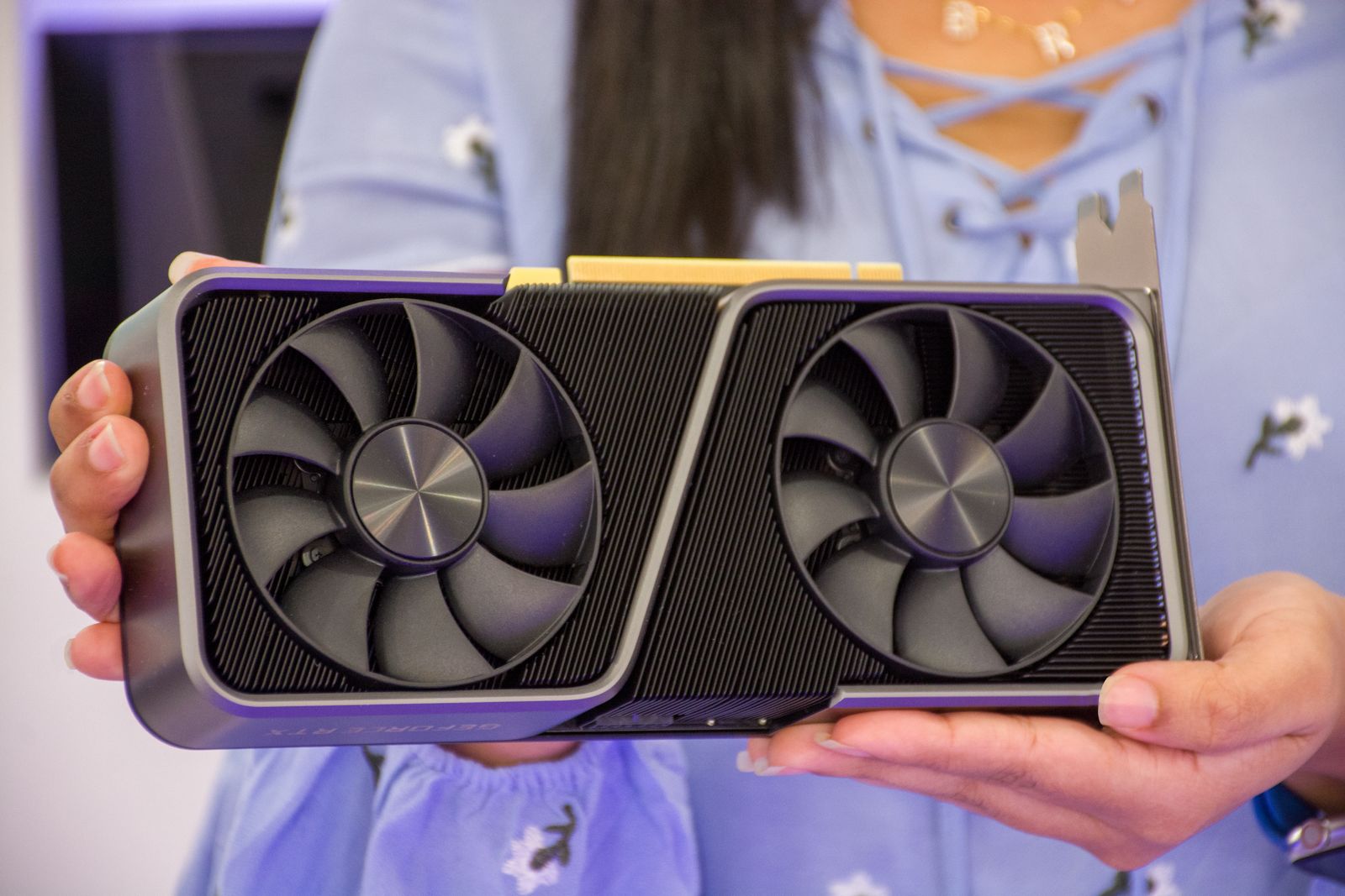 Person holding a high-performance graphics card